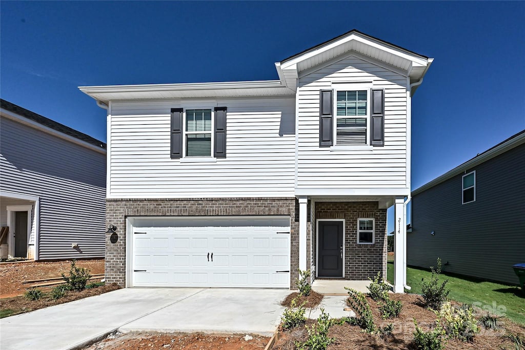 1449 31st St NE, Conover, NC 28613 - view of front of home featuring brick siding, an attached garage, and concrete driveway