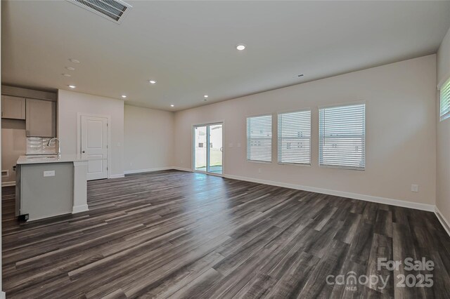1442 31st St NE, Conover, NC 28613 - unfurnished living room featuring dark wood-style flooring and recessed lighting