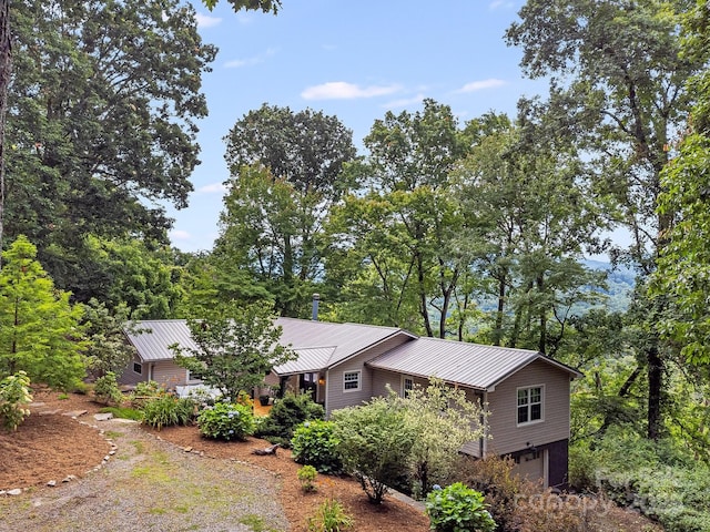 90 Reed Rd, Asheville, NC 28805 - view of side of home with a garage, driveway, and a metal roof