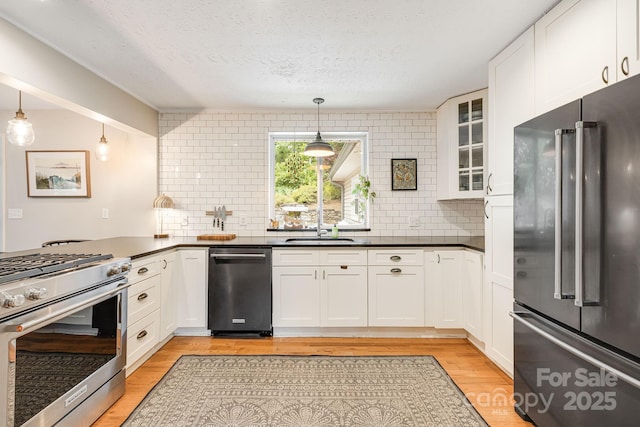90 Reed Rd, Asheville, NC 28805 - kitchen with high quality appliances, dark countertops, decorative backsplash, and a textured ceiling