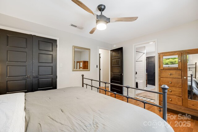 90 Reed Rd, Asheville, NC 28805 - bedroom featuring wood finished floors, a ceiling fan, and connected bathroom
