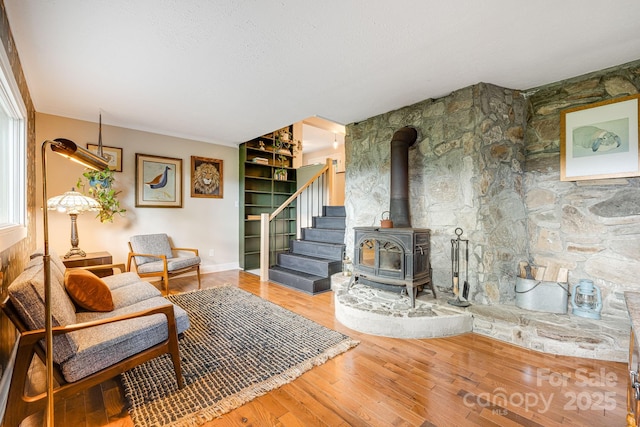 90 Reed Rd, Asheville, NC 28805 - living room featuring wood finished floors, a wood stove, and stairs