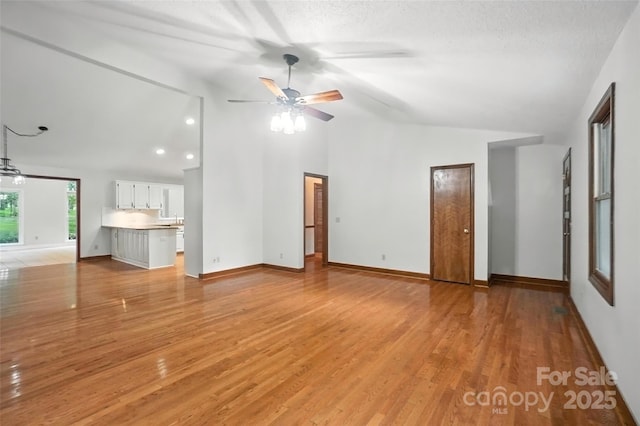 4323 Crow Rd, Monroe, NC 28112 - unfurnished living room with a ceiling fan, light wood finished floors, and high vaulted ceiling