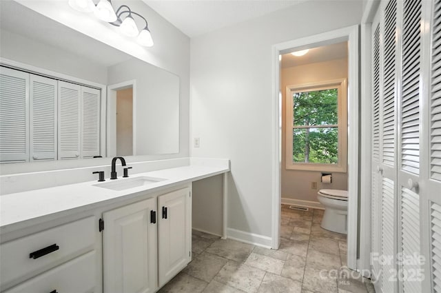 4323 Crow Rd, Monroe, NC 28112 - bathroom featuring a closet, vanity, and stone tile flooring