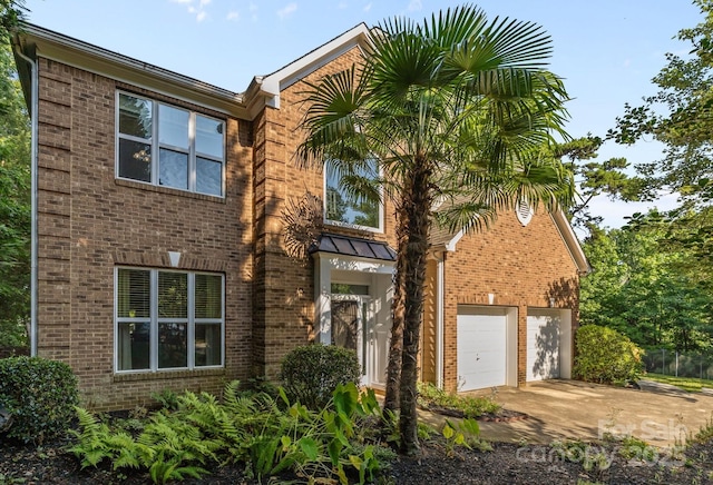 13934 Kings Carriage Ln, Charlotte, NC 28278 - view of front of house with brick siding, concrete driveway, and a garage