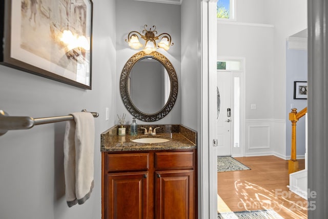 13934 Kings Carriage Ln, Charlotte, NC 28278 - bathroom with wood finished floors, vanity, and wainscoting