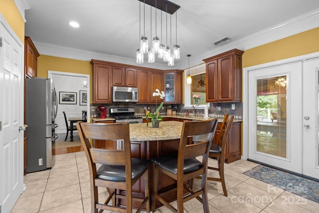 13934 Kings Carriage Ln, Charlotte, NC 28278 - kitchen featuring stainless steel appliances, ornamental molding, light tile patterned floors, tasteful backsplash, and a center island
