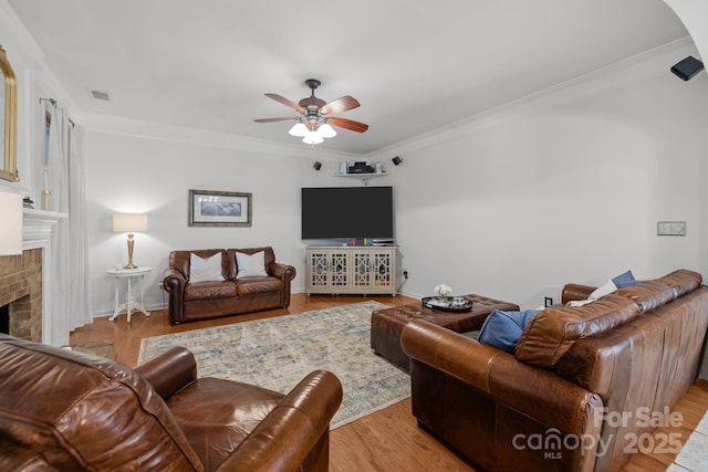 13934 Kings Carriage Ln, Charlotte, NC 28278 - living room featuring ceiling fan, crown molding, a fireplace, and wood finished floors