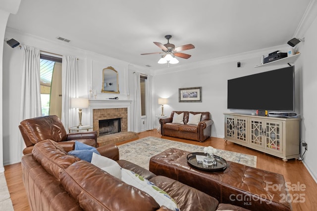 13934 Kings Carriage Ln, Charlotte, NC 28278 - living room featuring a ceiling fan, crown molding, a fireplace, and wood finished floors
