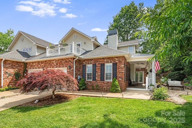 609 Carriage Commons Dr, Hendersonville, NC 28791 - traditional home with brick siding, a ceiling fan, a balcony, roof with shingles, and a front lawn