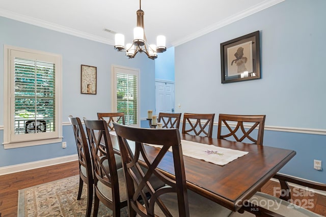 609 Carriage Commons Dr, Hendersonville, NC 28791 - dining area featuring a chandelier, wood finished floors, and ornamental molding
