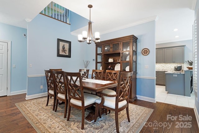 609 Carriage Commons Dr, Hendersonville, NC 28791 - dining space with a chandelier, wood finished floors, and crown molding