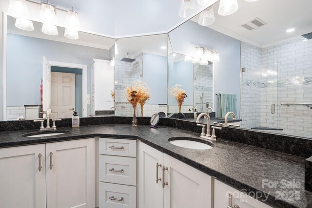 609 Carriage Commons Dr, Hendersonville, NC 28791 - bathroom featuring a stall shower, double vanity, and ornamental molding