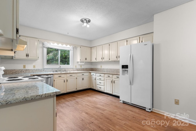 1748 4th Street Ct NE, Hickory, NC 28601 - kitchen with white appliances, light wood finished floors, a textured ceiling, and light stone counters