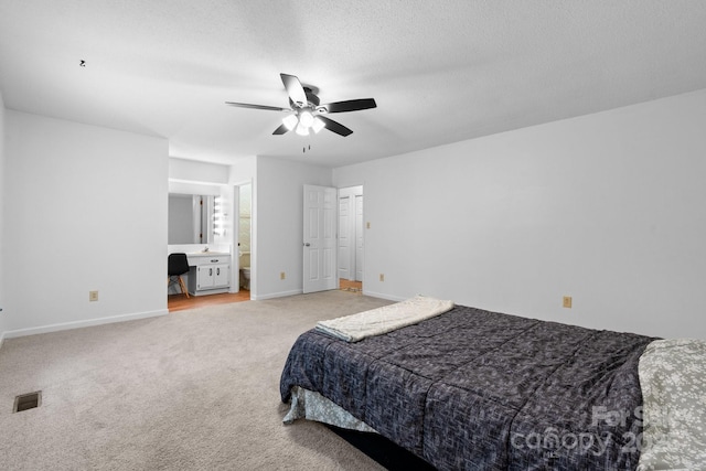 1748 4th Street Ct NE, Hickory, NC 28601 - bedroom with light carpet, a desk, a ceiling fan, ensuite bath, and a textured ceiling