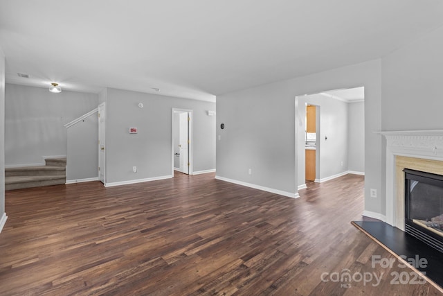 1901 Summit Ridge Ln, Kannapolis, NC 28083 - unfurnished living room featuring stairway, dark wood-type flooring, and a fireplace