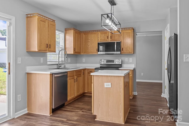 1901 Summit Ridge Ln, Kannapolis, NC 28083 - kitchen with appliances with stainless steel finishes, dark wood-style floors, light countertops, a center island, and hanging light fixtures