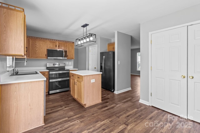 1901 Summit Ridge Ln, Kannapolis, NC 28083 - kitchen featuring appliances with stainless steel finishes, dark wood-style floors, a kitchen island, light countertops, and hanging light fixtures