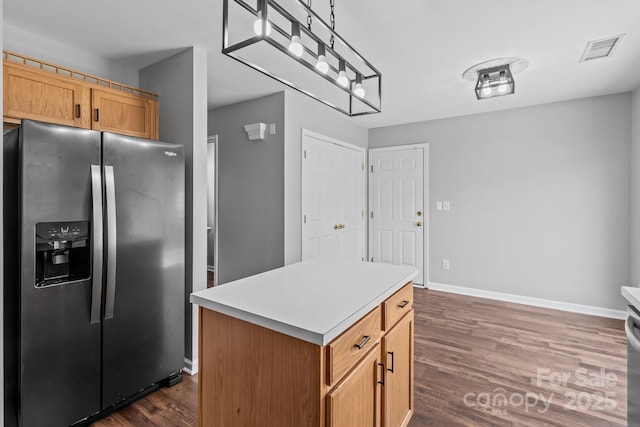 1901 Summit Ridge Ln, Kannapolis, NC 28083 - kitchen featuring stainless steel fridge, dark wood finished floors, a kitchen island, light countertops, and decorative light fixtures