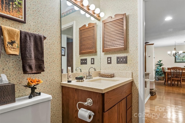 26B Cedarwood Trl, Asheville, NC 28806 - bathroom with wood finished floors, vanity, wallpapered walls, and a chandelier