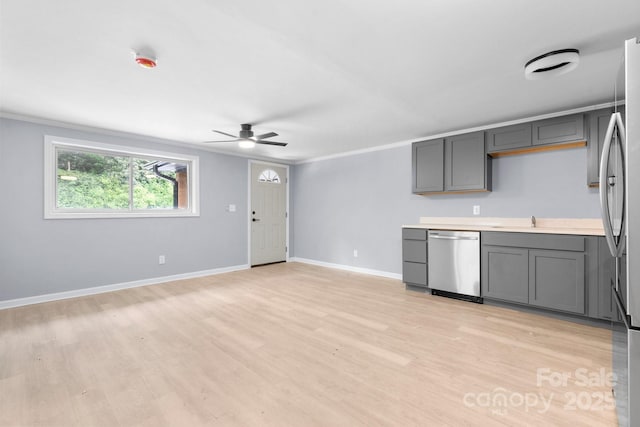 1175 Bamboo Rd, Boone, NC 28607 - kitchen featuring appliances with stainless steel finishes, gray cabinets, ceiling fan, light wood-style flooring, and crown molding