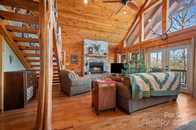 197 First Broad Dr, Bostic, NC 28018 - living area with a wooden ceiling with exposed beams, stairs, a ceiling fan, light wood-type flooring, and wooden walls