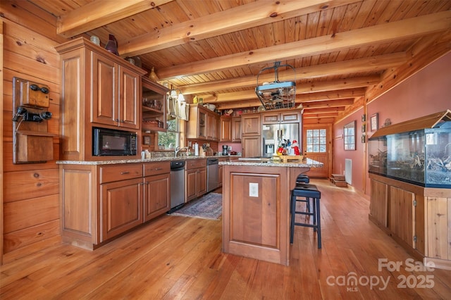 197 First Broad Dr, Bostic, NC 28018 - kitchen with appliances with stainless steel finishes, light wood-style floors, a kitchen island, a kitchen bar, and a wood ceiling with exposed beams