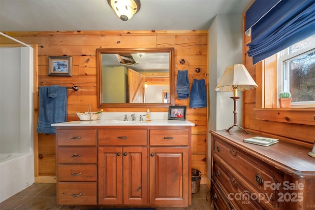 197 First Broad Dr, Bostic, NC 28018 - bathroom with vanity, wood walls, tile patterned flooring, and shower / tub combination