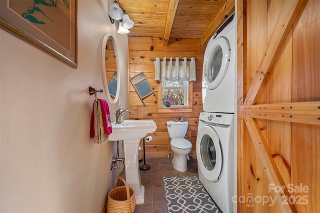 197 First Broad Dr, Bostic, NC 28018 - washroom with stacked washer / dryer, wood walls, wood ceiling, and tile patterned flooring