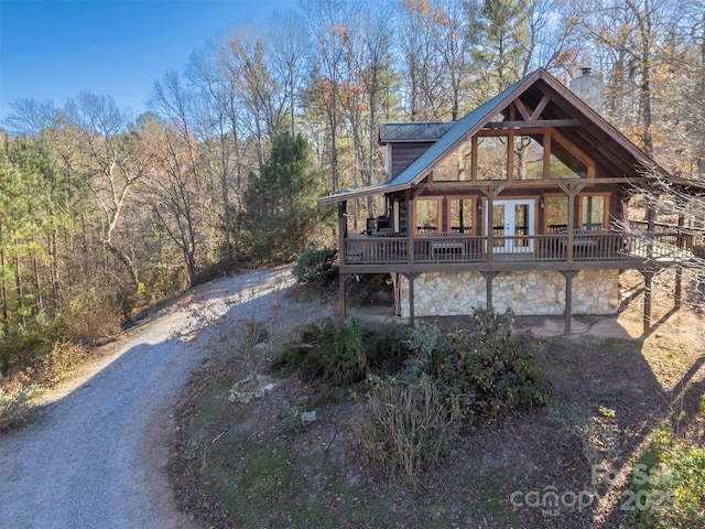 197 First Broad Dr, Bostic, NC 28018 - back of house featuring a chimney, french doors, a deck, a forest view, and stone siding
