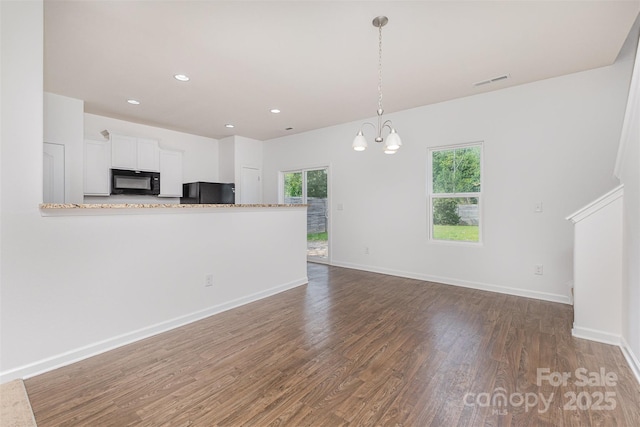 1404 Waylon Ave, Gastonia, NC 28054 - unfurnished living room featuring wood finished floors, recessed lighting, and a chandelier