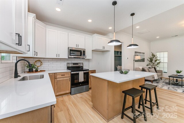 3486 Winters St, Newton, NC 28658 - kitchen featuring appliances with stainless steel finishes, light wood finished floors, decorative backsplash, and recessed lighting