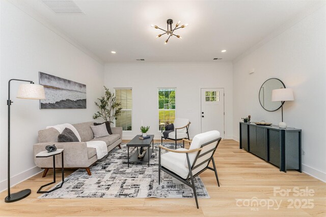 3486 Winters St, Newton, NC 28658 - living room featuring crown molding, light wood-type flooring, a chandelier, and recessed lighting