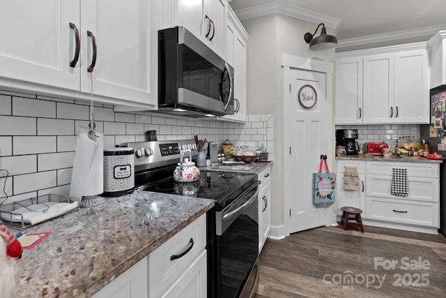203 Poplins Grove Church Rd, Albemarle, NC 28001 - kitchen with stainless steel appliances, ornamental molding, backsplash, dark wood finished floors, and white cabinets