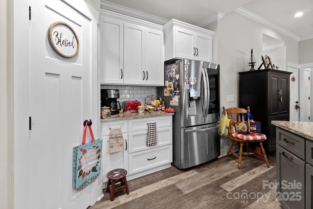 203 Poplins Grove Church Rd, Albemarle, NC 28001 - kitchen featuring stainless steel fridge, wood finished floors, ornamental molding, white cabinets, and decorative backsplash