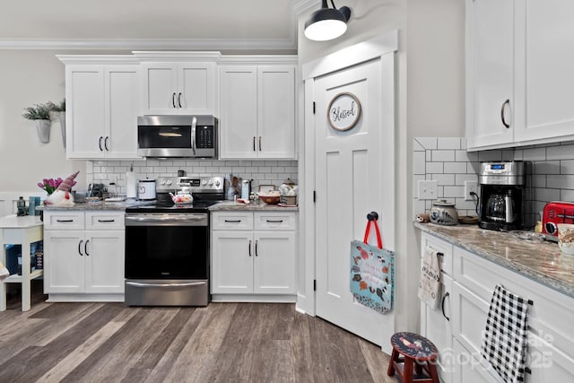 203 Poplins Grove Church Rd, Albemarle, NC 28001 - kitchen with appliances with stainless steel finishes, crown molding, white cabinets, tasteful backsplash, and dark wood-style flooring
