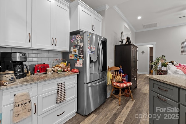 203 Poplins Grove Church Rd, Albemarle, NC 28001 - kitchen with stainless steel refrigerator with ice dispenser, crown molding, dark wood-style flooring, white cabinets, and backsplash