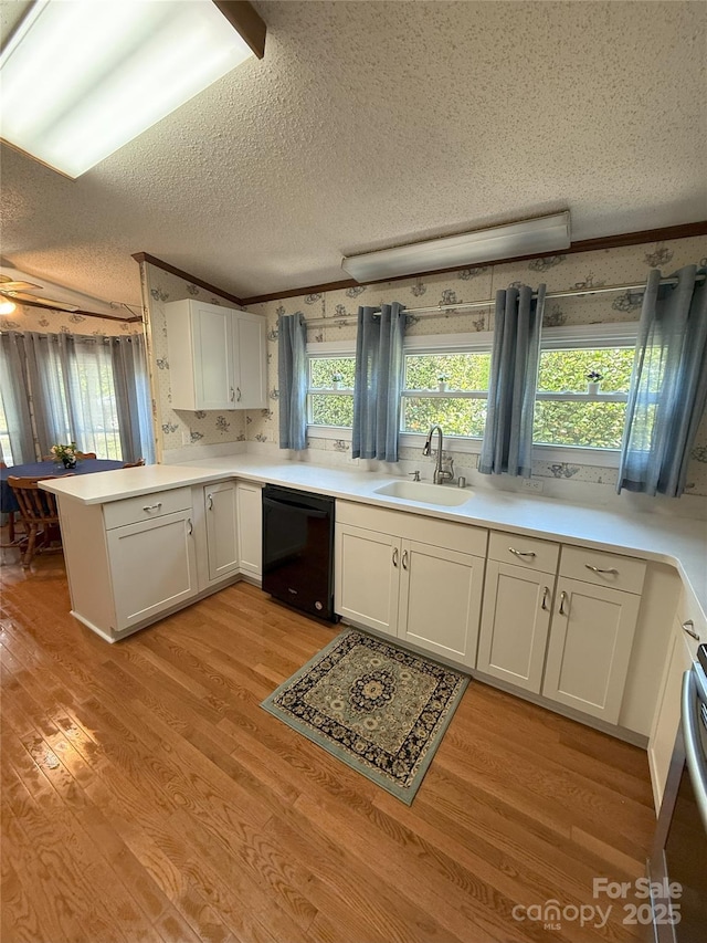 400 Archibald Rd, Concord, NC 28025 - kitchen with dishwasher, a textured ceiling, a peninsula, white cabinetry, and light wood-type flooring