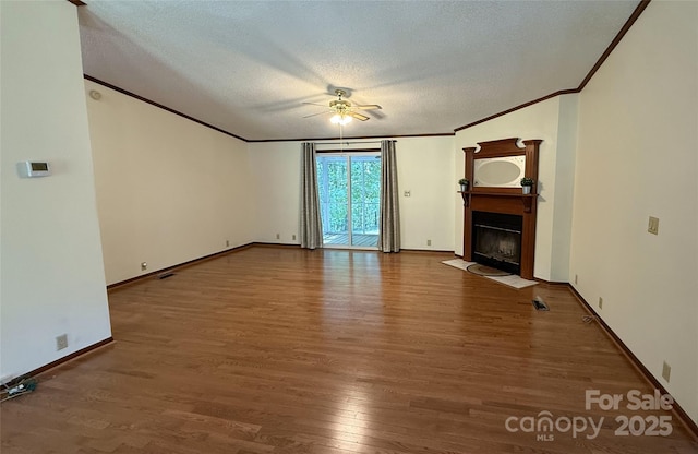 400 Archibald Rd, Concord, NC 28025 - unfurnished living room featuring crown molding, ceiling fan, wood finished floors, a fireplace with flush hearth, and a textured ceiling