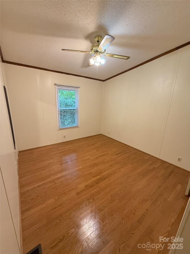 400 Archibald Rd, Concord, NC 28025 - unfurnished room featuring ornamental molding, a textured ceiling, a ceiling fan, and wood finished floors