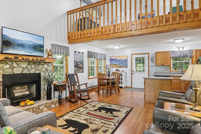 84 Hawk Nest Rd, Maggie Valley, NC 28751 - living area featuring a high ceiling, wood finished floors, and a stone fireplace