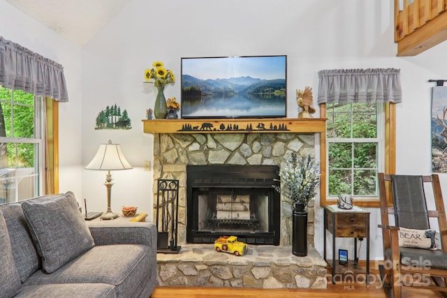 84 Hawk Nest Rd, Maggie Valley, NC 28751 - living area with lofted ceiling, a stone fireplace, and wood finished floors