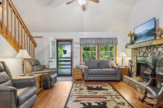 84 Hawk Nest Rd, Maggie Valley, NC 28751 - living area with vaulted ceiling, ceiling fan, wood finished floors, stairway, and a stone fireplace
