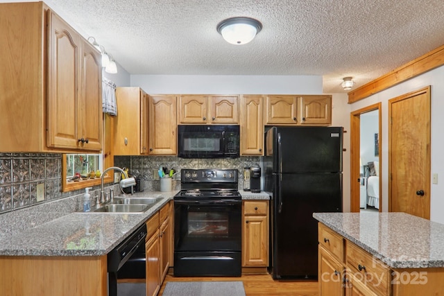 84 Hawk Nest Rd, Maggie Valley, NC 28751 - kitchen featuring black appliances, a textured ceiling, light wood finished floors, tasteful backsplash, and stone countertops