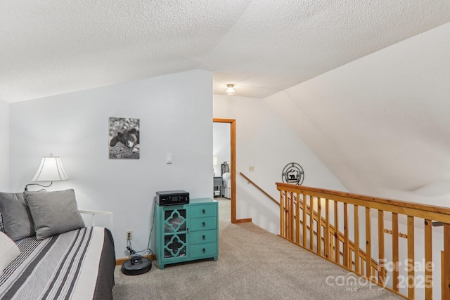 84 Hawk Nest Rd, Maggie Valley, NC 28751 - living area featuring vaulted ceiling, an upstairs landing, carpet flooring, and a textured ceiling