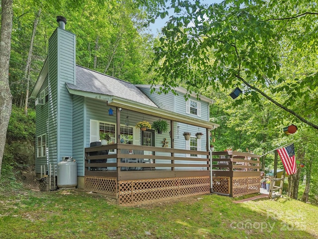 84 Hawk Nest Rd, Maggie Valley, NC 28751 - back of house with a deck, a chimney, a lawn, and roof with shingles