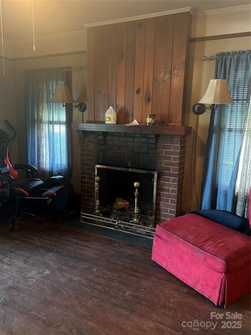 3220 Harmony Hwy, Harmony, NC 28634 - living area with ornamental molding, wood finished floors, and a brick fireplace