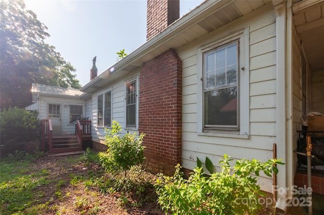 3220 Harmony Hwy, Harmony, NC 28634 - view of property exterior with a chimney, brick siding, and a wooden deck