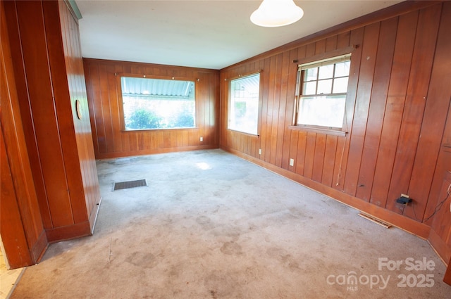 3220 Harmony Hwy, Harmony, NC 28634 - carpeted spare room featuring plenty of natural light and wood walls