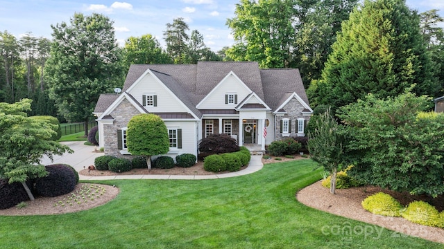 132 Ragsdale Trl, Mooresville, NC 28117 - craftsman house featuring stone siding, a standing seam roof, a front yard, a metal roof, and a shingled roof